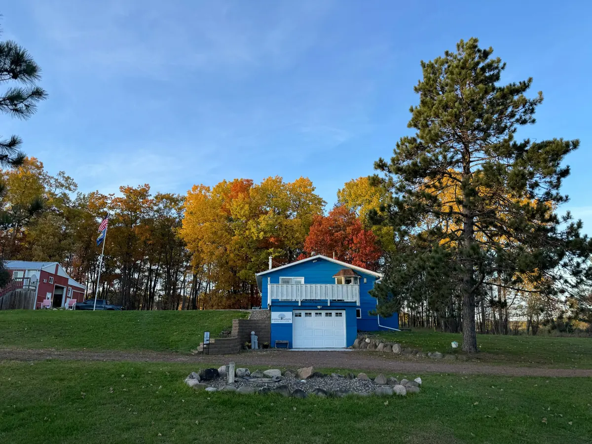 The Evenson Holistic office on the homestead, under fall color and a tall pine