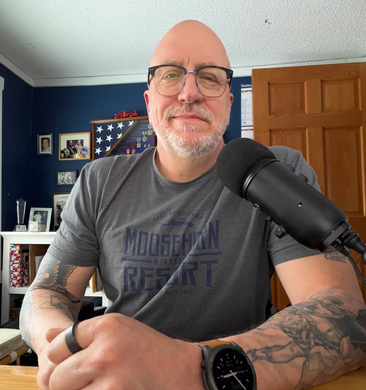Jeff at his desk behind a microphone, recording Morning Coffee